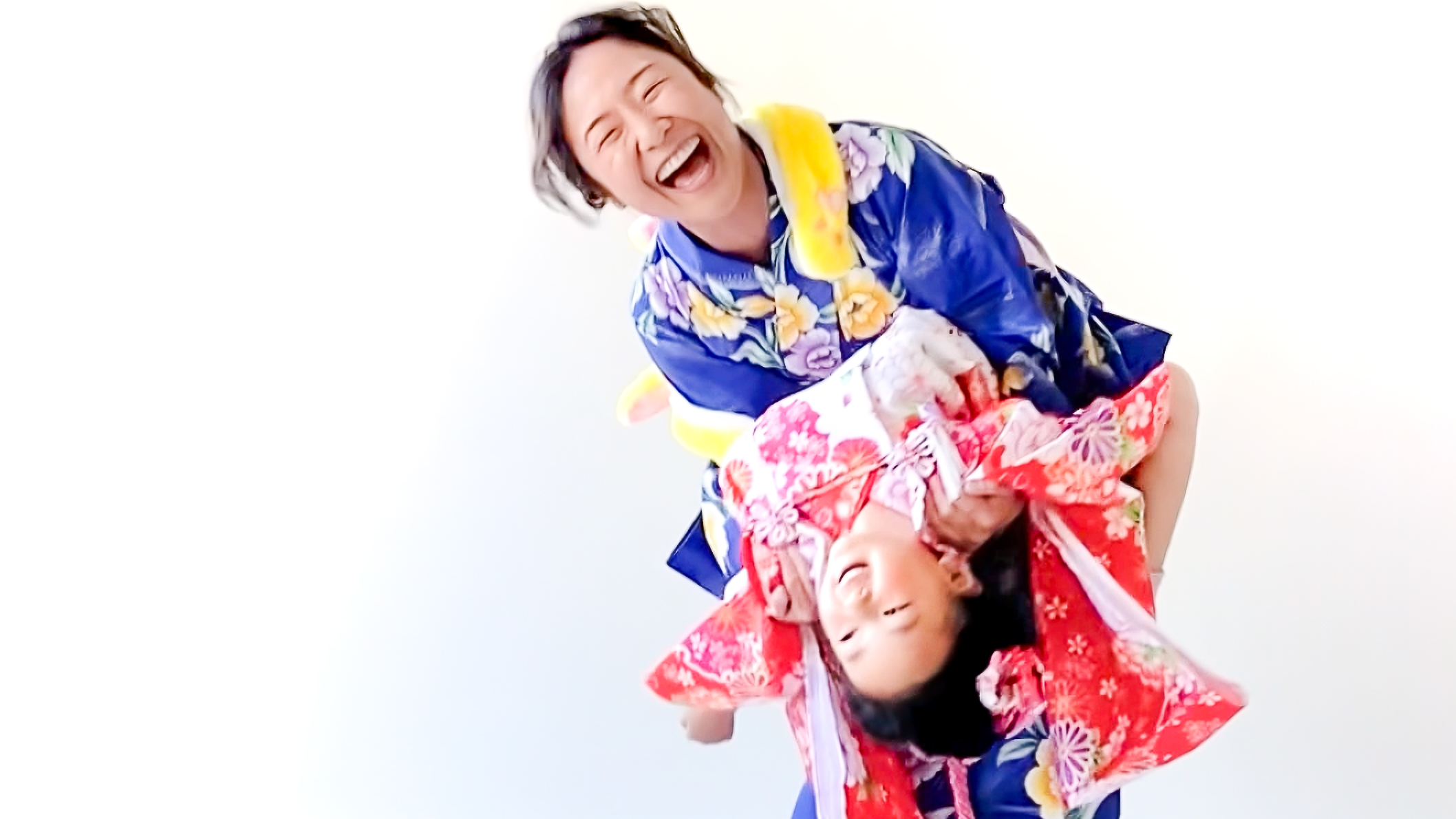 A kimono dresser helping a nervous 3-year-old relax during Shichi-Go-San by creating a joyful, safe moment — Strange Aunt Theory