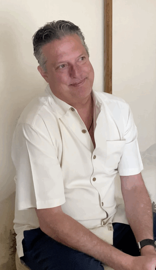 Father watching his daughter during a seijin celebration in Los Angeles, smiling softly before her kimono photo shoot